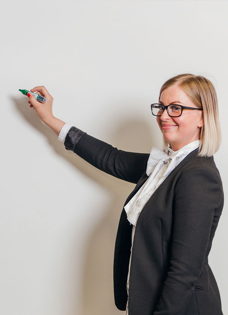 A corporate meeting room with a whiteboard roll, filled with diagrams and brainstorming notes from a team meeting