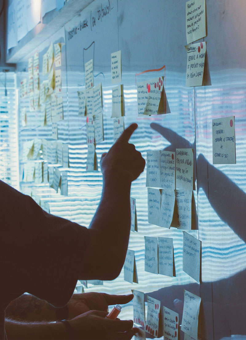 A teacher using markers on a whiteboard roll in a classroom