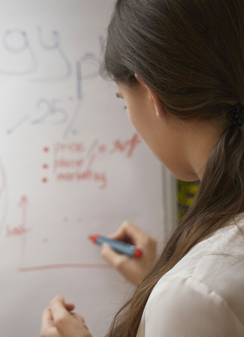 A whiteboard roll displayed on a classroom wall.